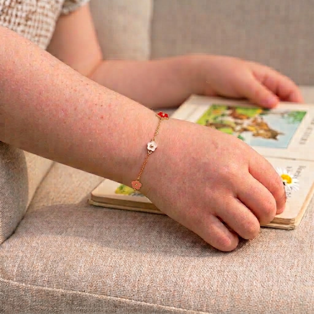 Child wearing 14K solid gold colorful flower epoxy bracelet, 5.5 inch size
