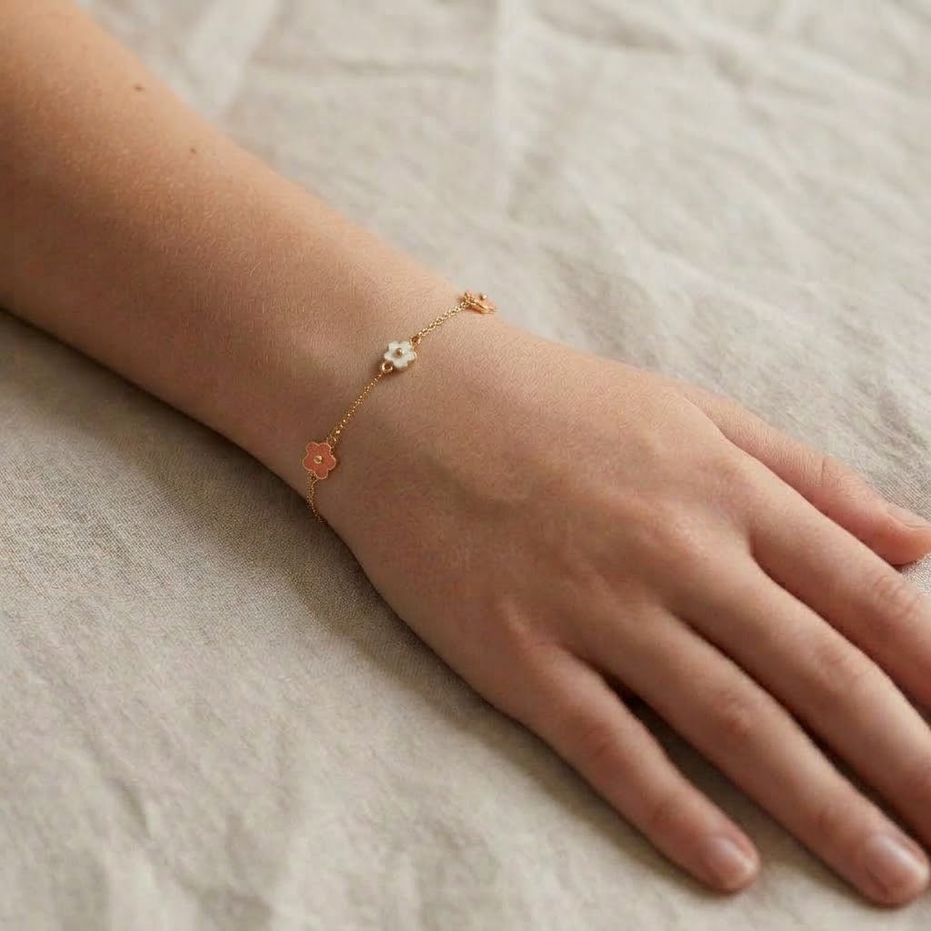 Child wearing 14K solid gold pink and white flower epoxy bracelet, 6.5 inch size