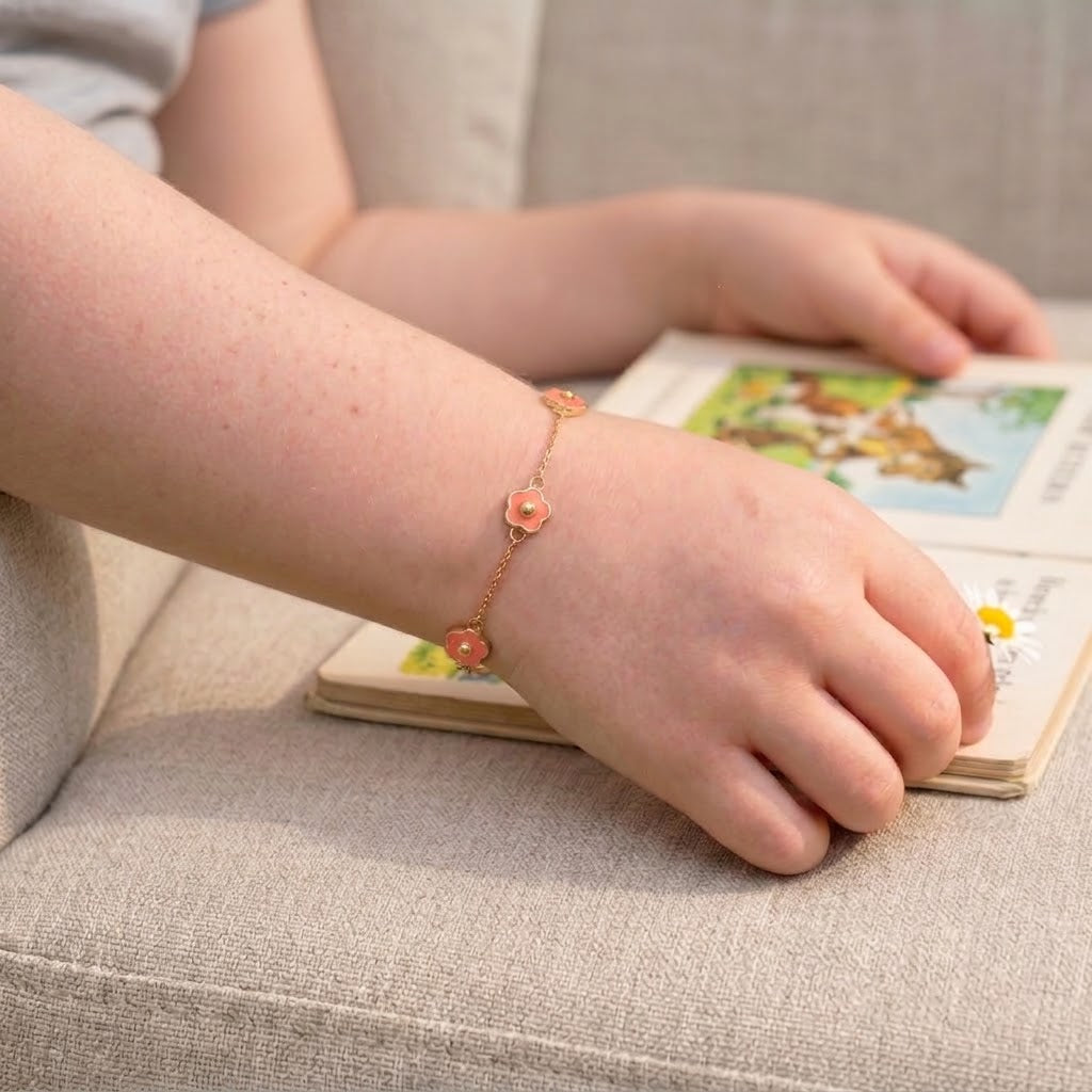 Child wearing 14K solid gold pink flower epoxy bracelet, 5.5 inch size