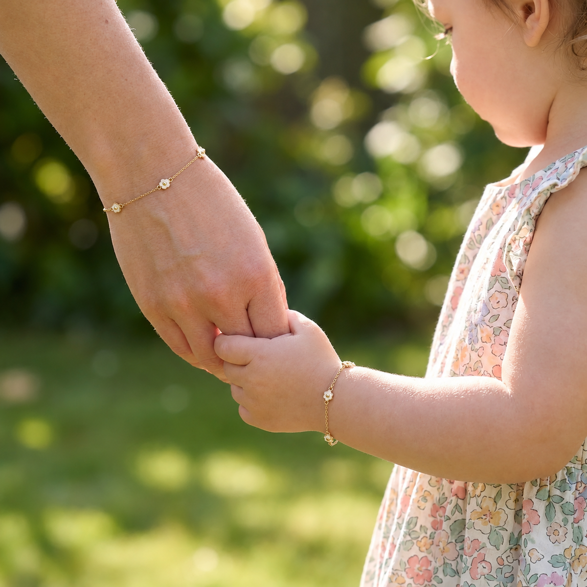 Mommy and child wearing matching 14K solid gold triple white flower bracelets