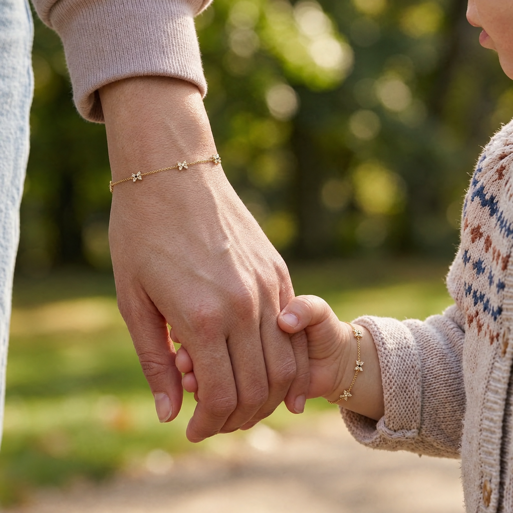 Mommy and child wearing matching 14K solid gold ribbon CZ bracelets