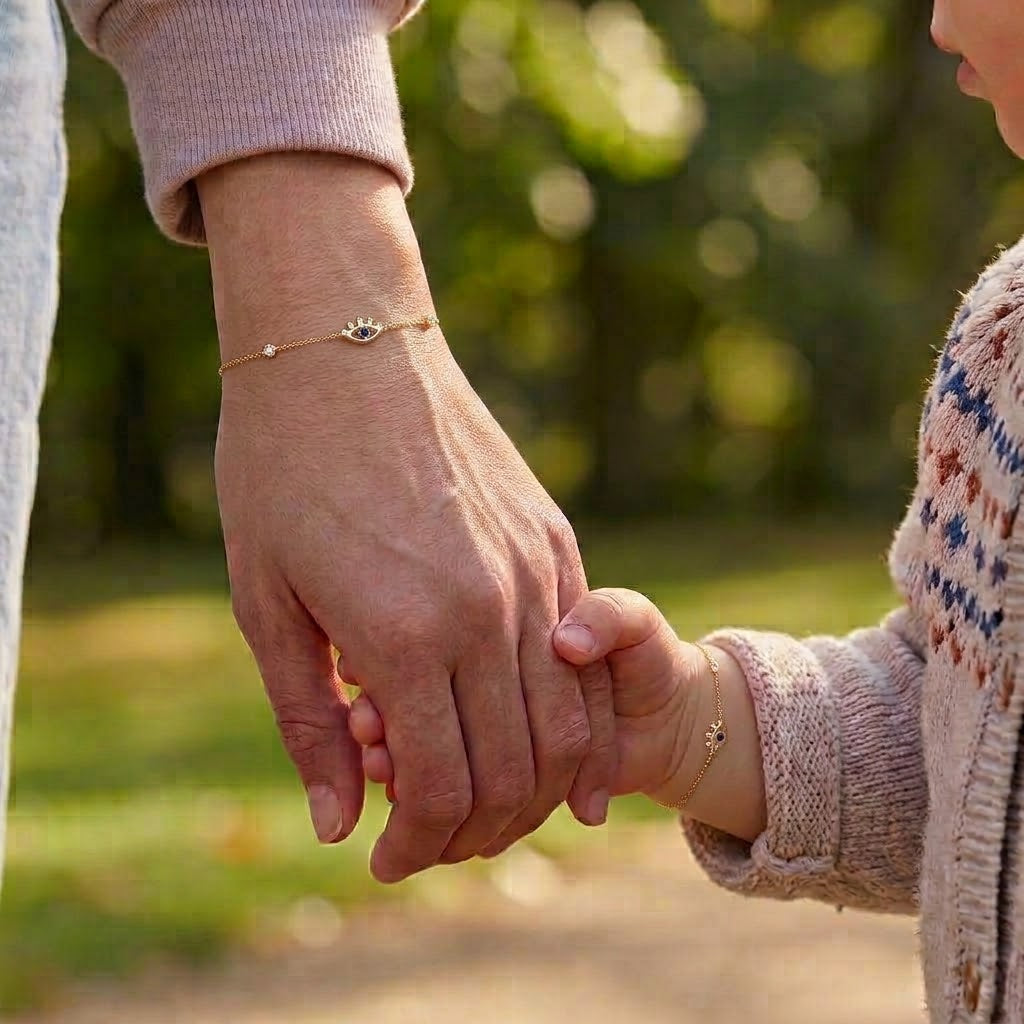 Mommy and child wearing matching 14K solid gold evil eye CZ bracelets