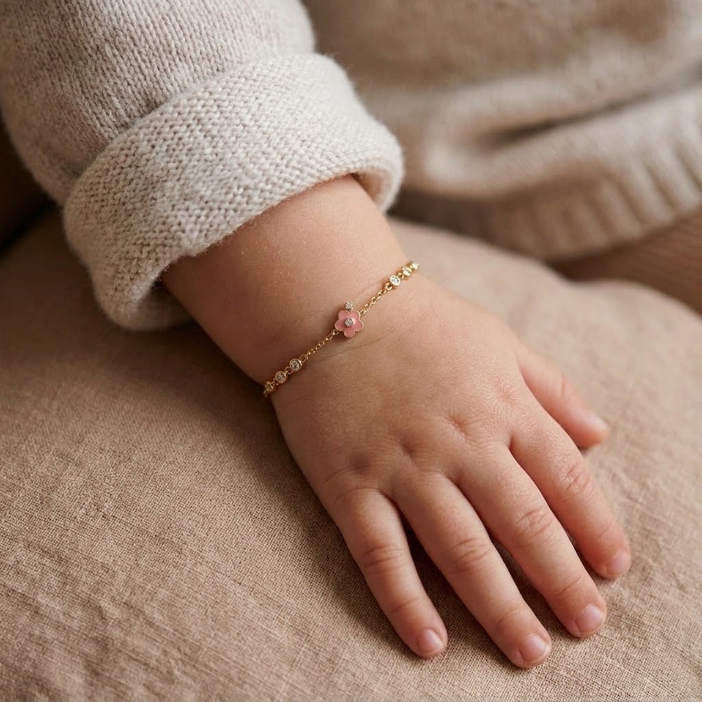 Child wearing 14K solid gold pink flower bracelet, 5.5 inch size