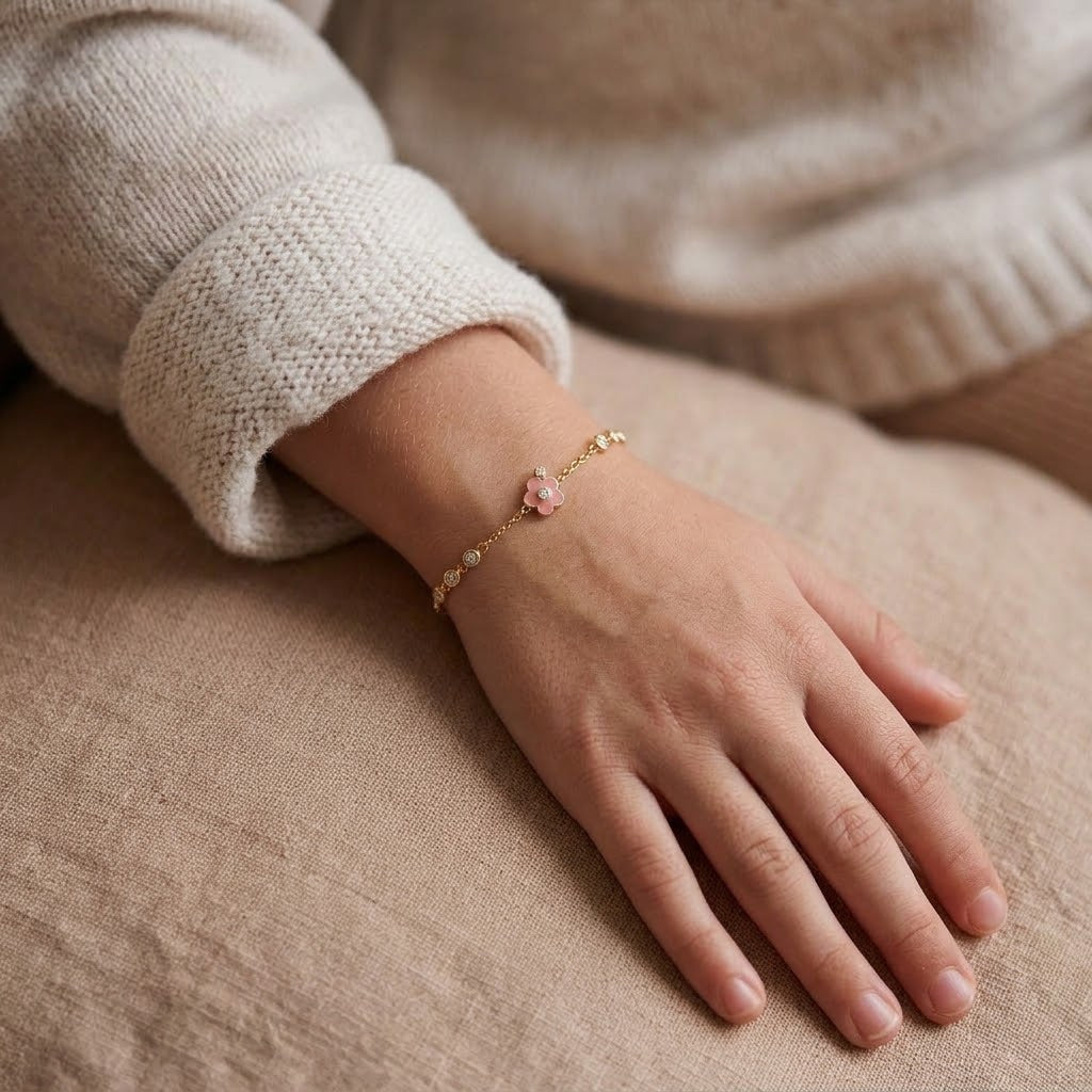 Child wearing 14K solid gold pink flower bracelet, 6.5 inch size