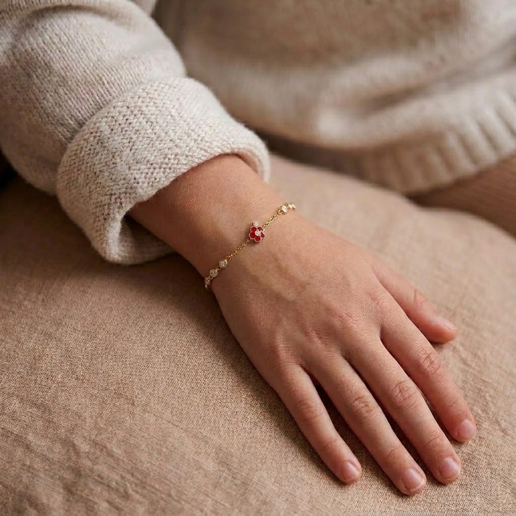 Child wearing 14K solid gold red flower bracelet, 6.5 inch size