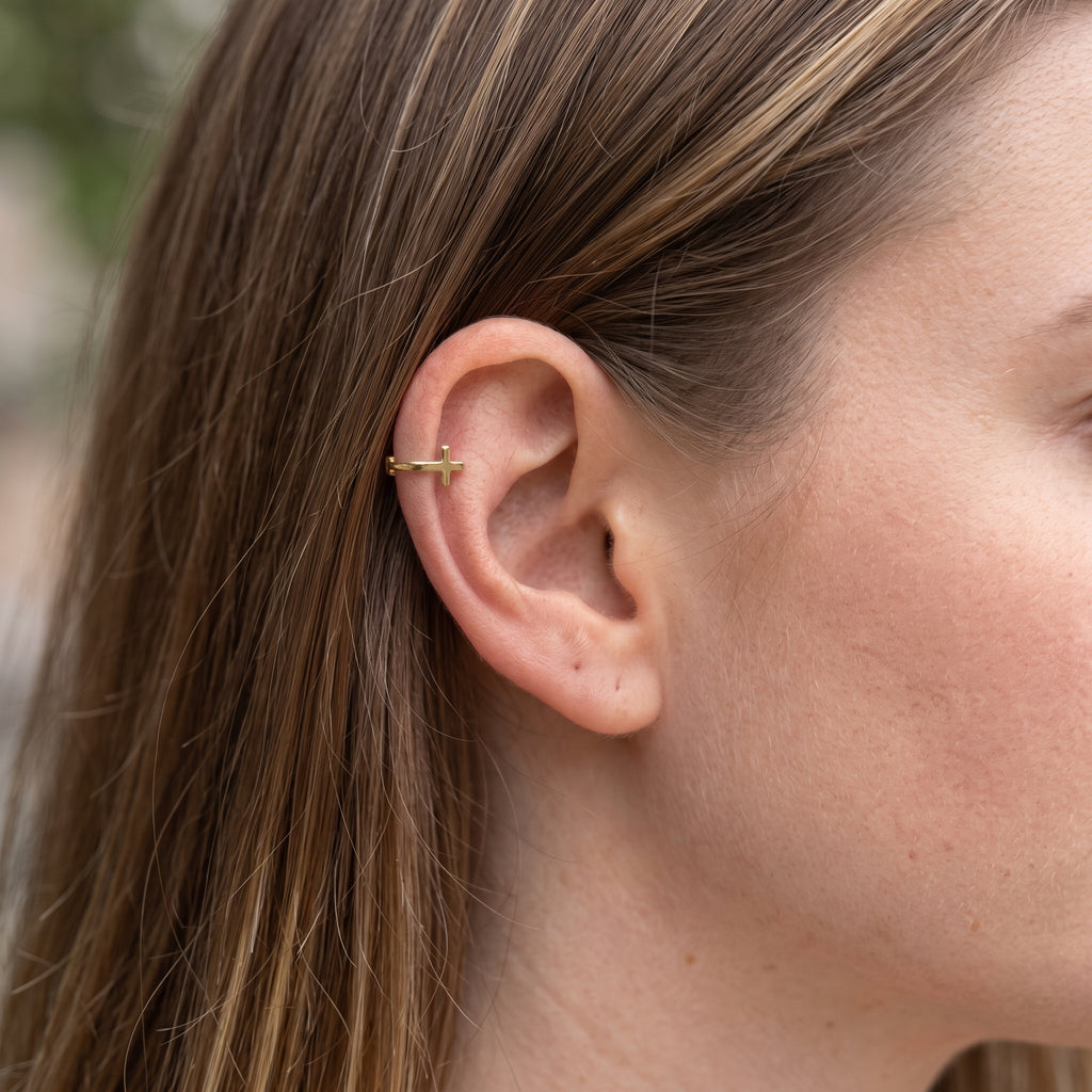 14K solid gold cross cartilage hoop worn in cartilage piercing