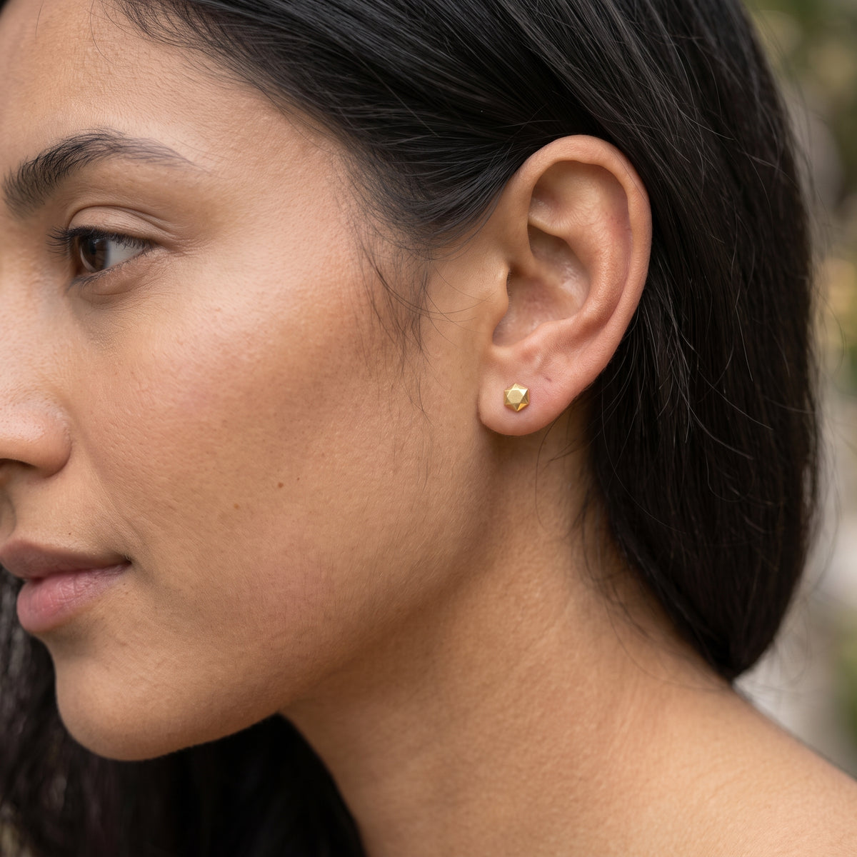 14K solid gold geometric stud earrings worn in ear