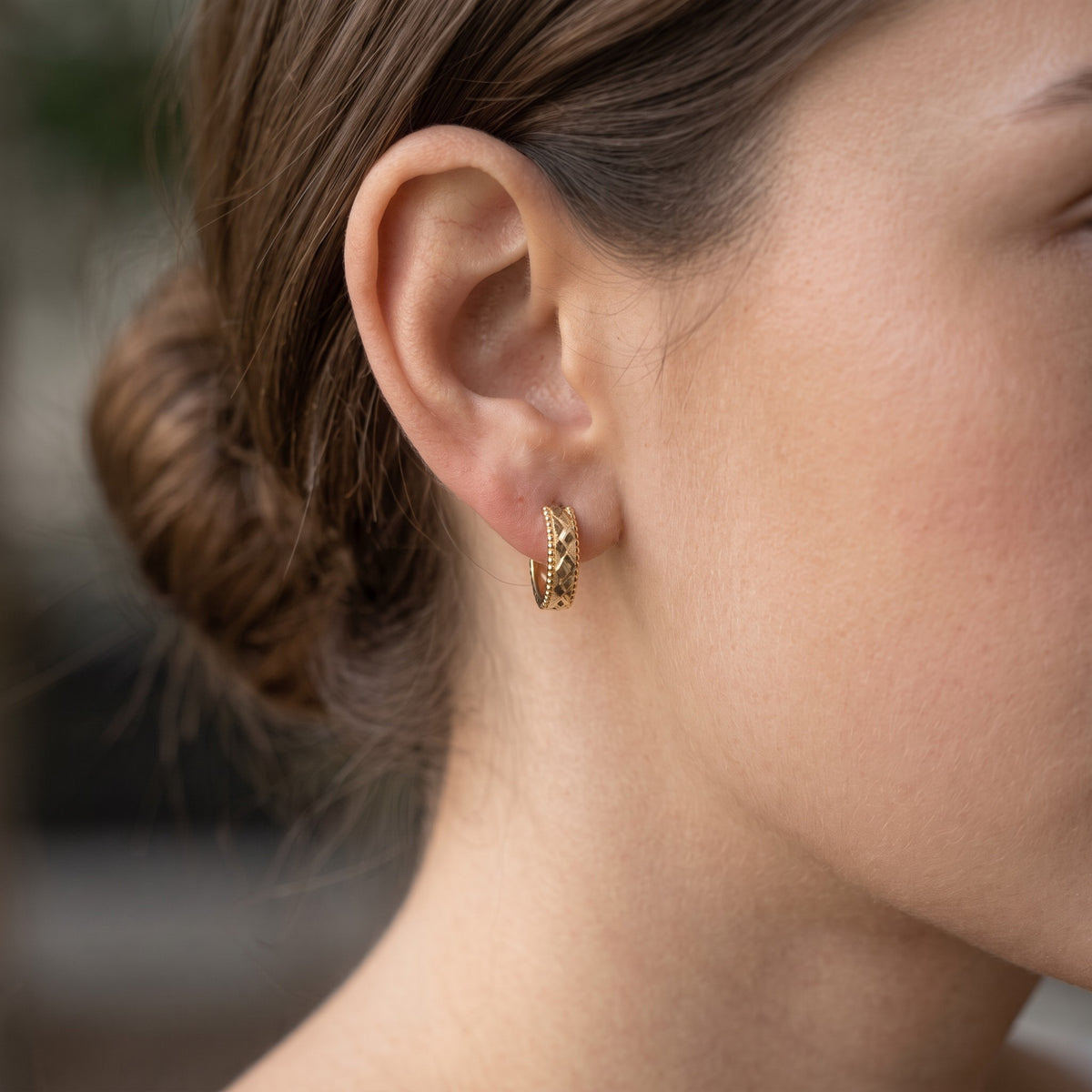 14K solid gold diamond cut hoop earrings worn in ear
