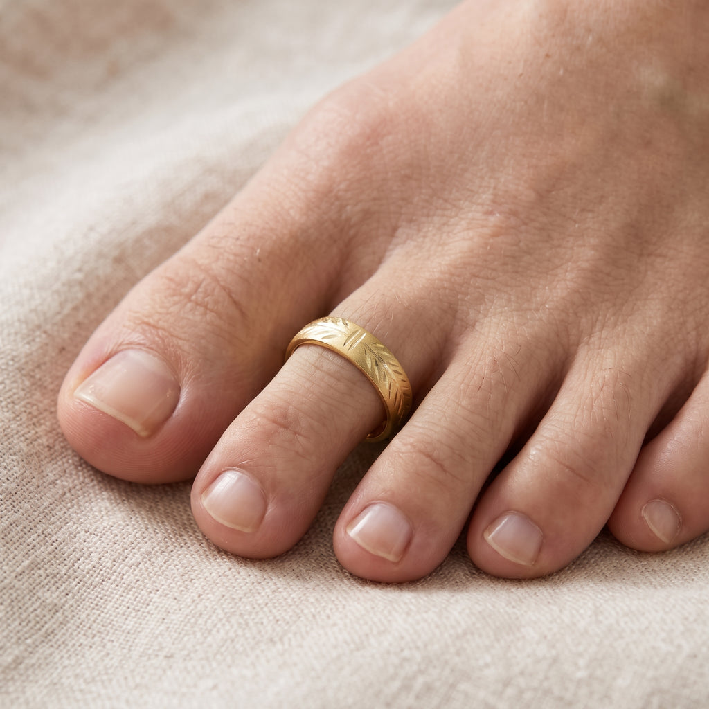 10K solid gold 4mm wide diamond-cut adjustable toe ring worn on foot