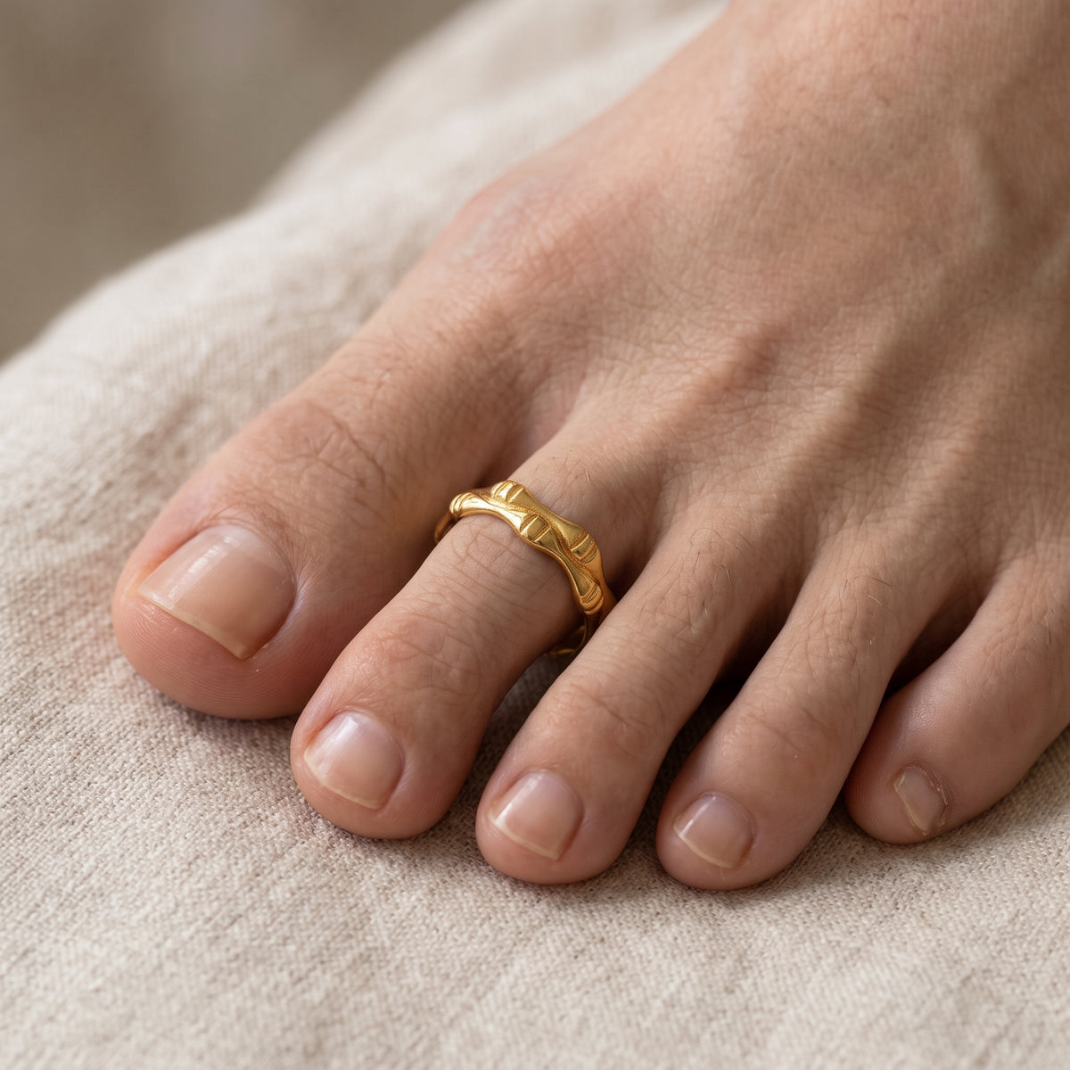 10K solid gold sculpted bamboo-design toe ring worn on foot
